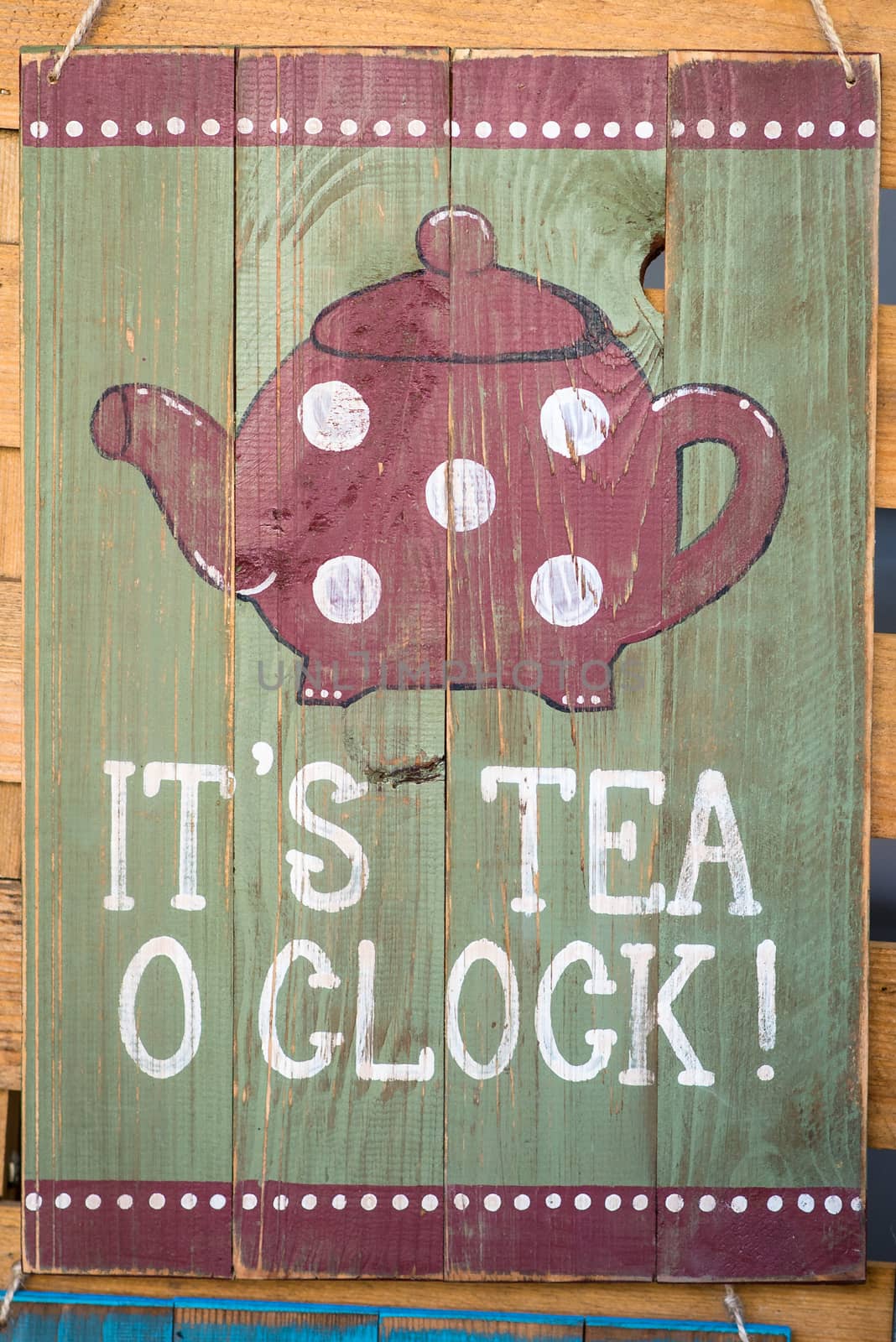 wooden board with the inscription 'It's tea o'clock'