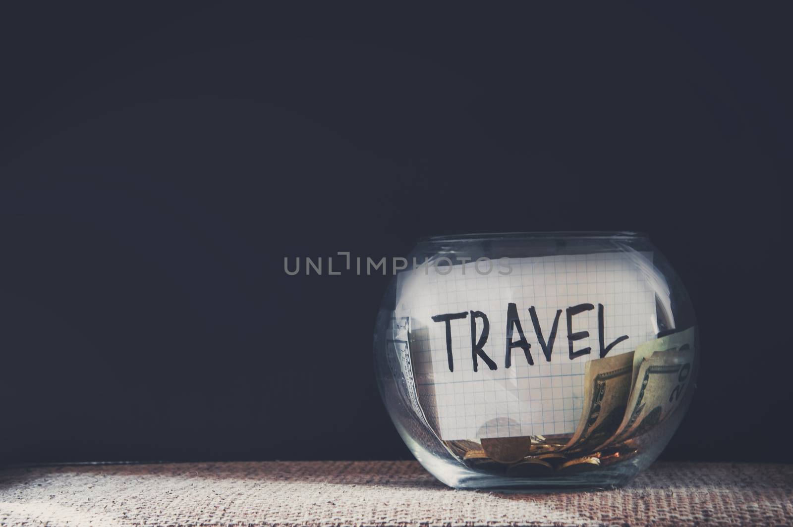 Jar labeled travel filled with money by natali_brill