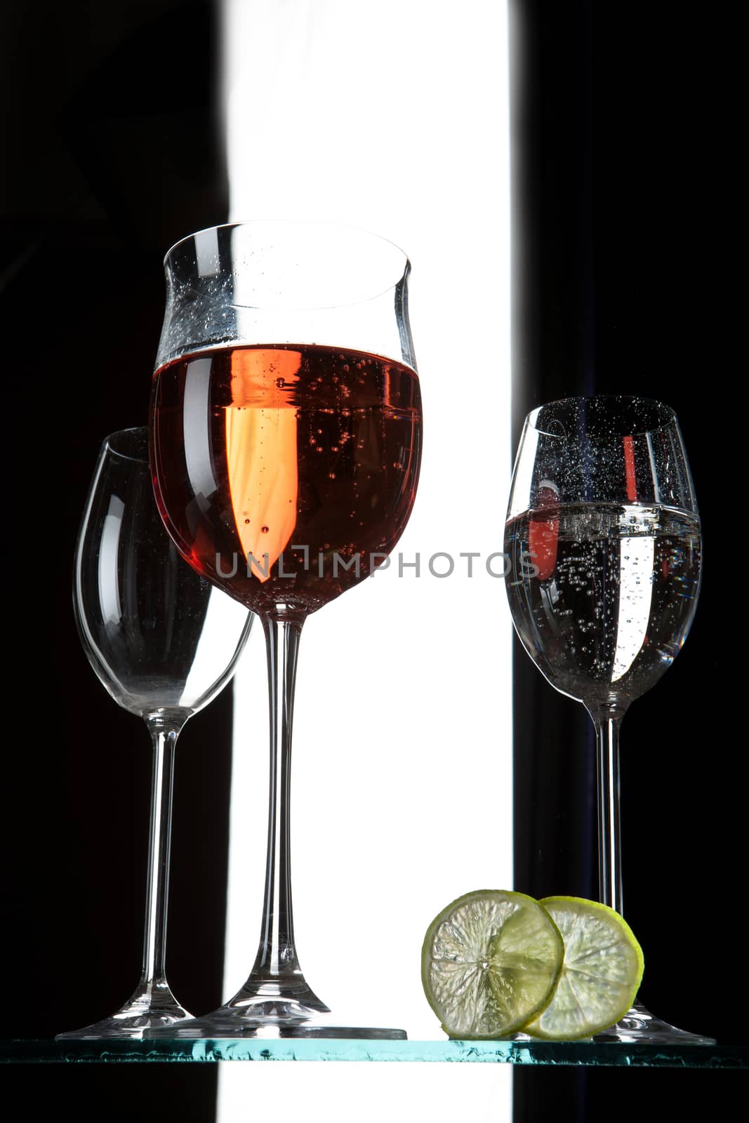 Glasses and beverages on a studio background