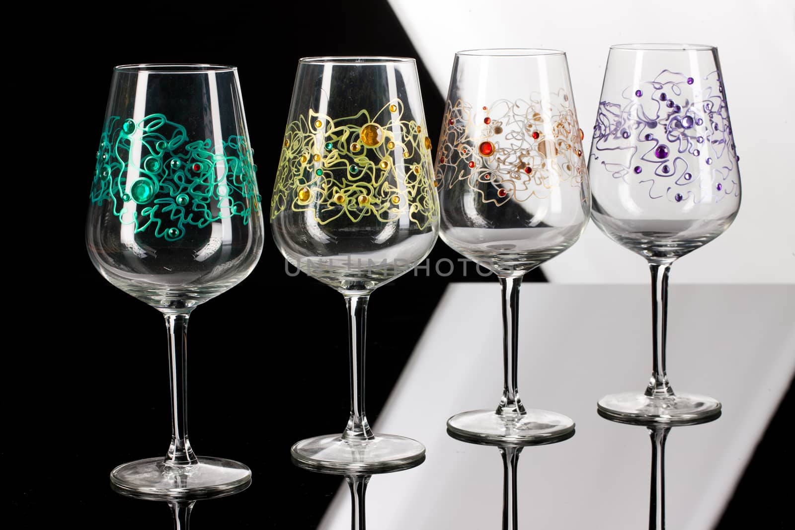 Wineglasses with painting on a glass studio background
