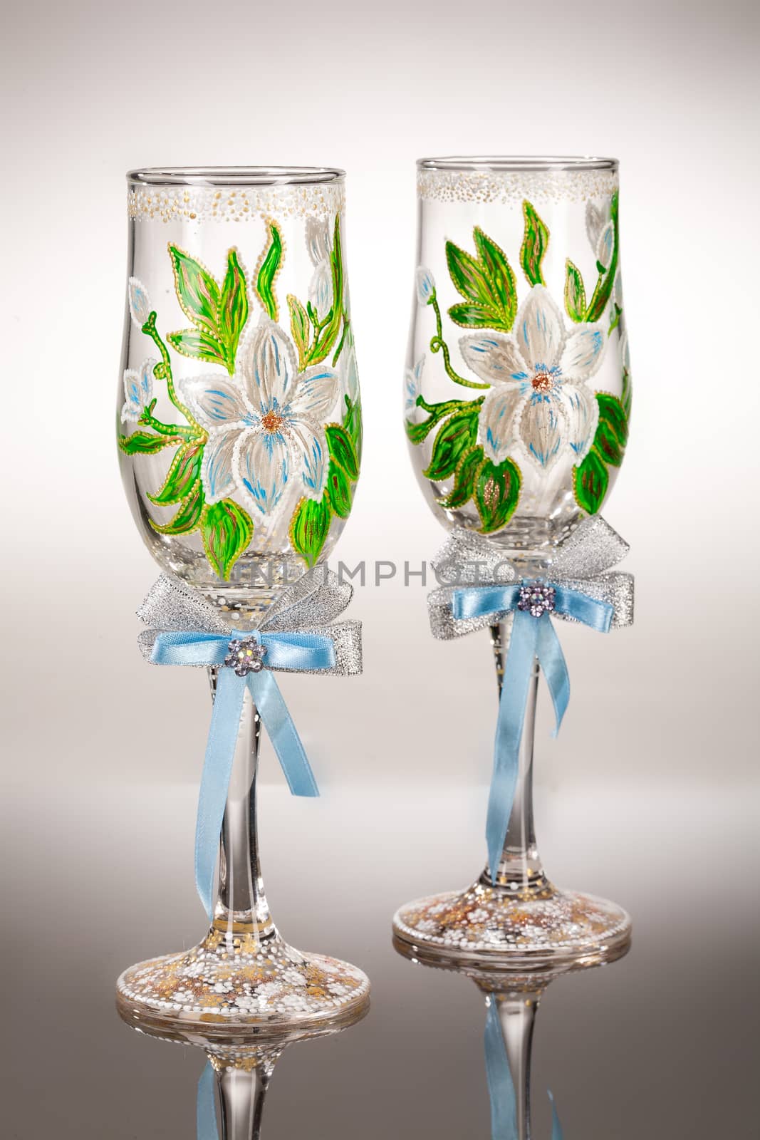 Wineglasses with painting on a glass studio background