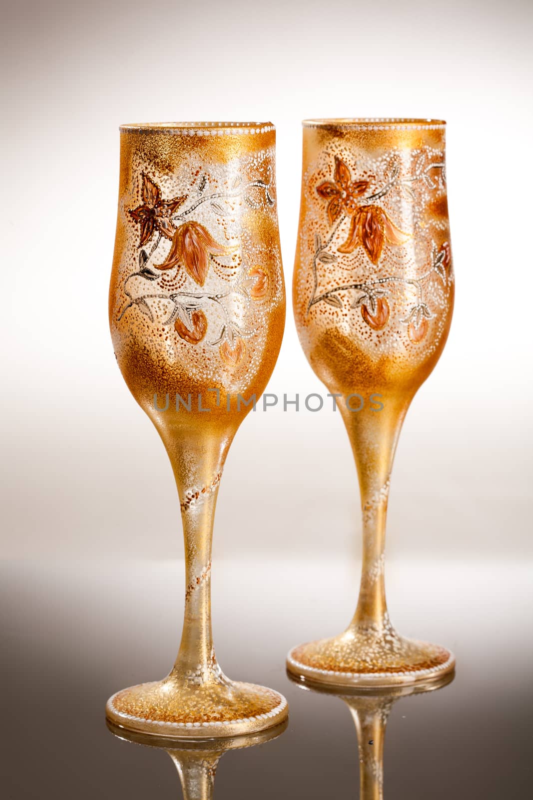 Wineglasses with painting on a glass studio background