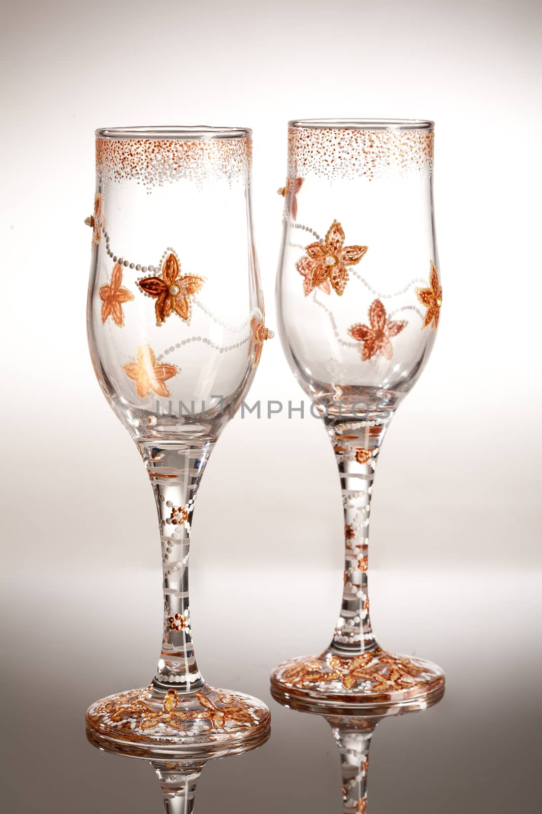 Wineglasses with painting on a glass studio background