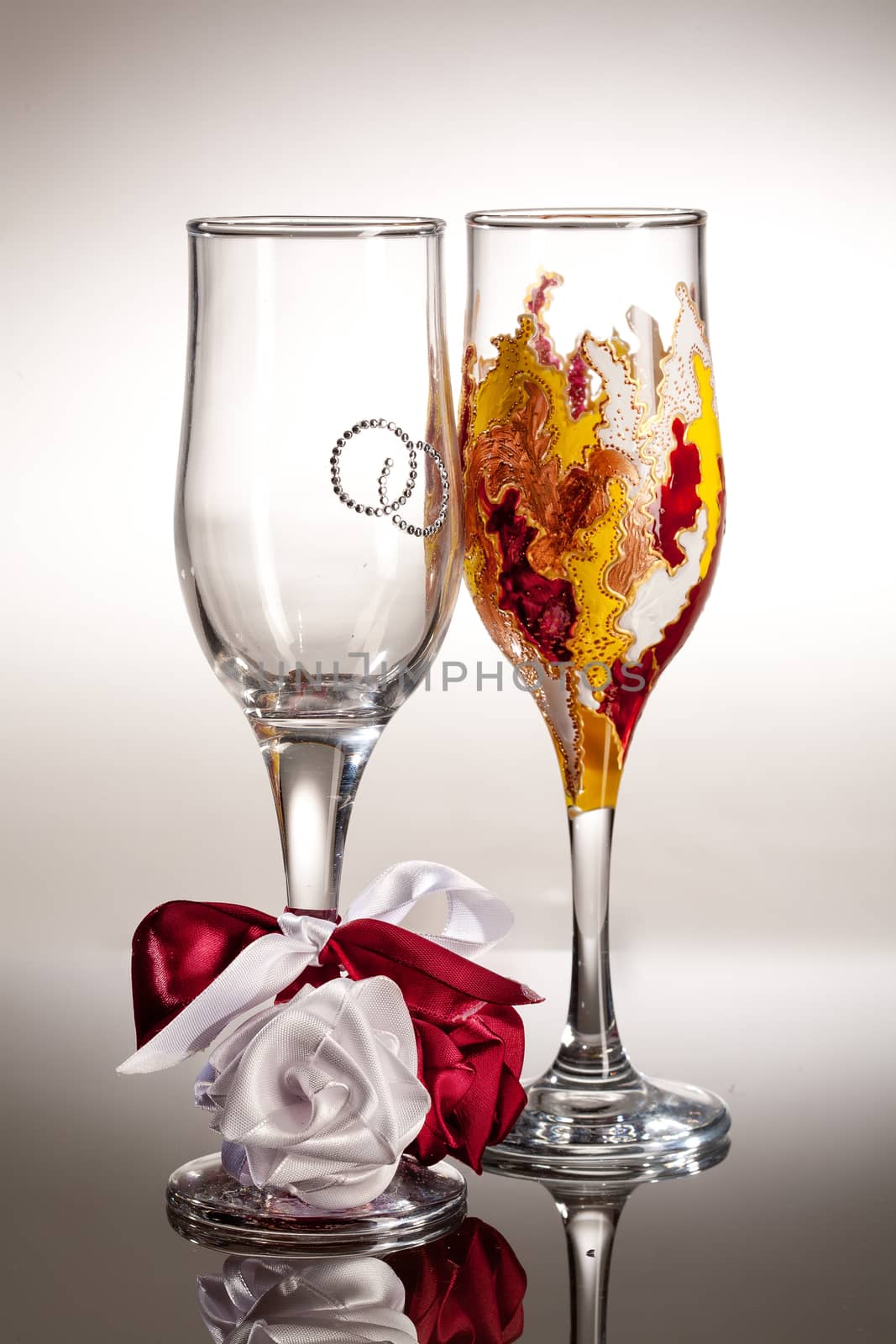 Wineglasses with painting on a glass studio background