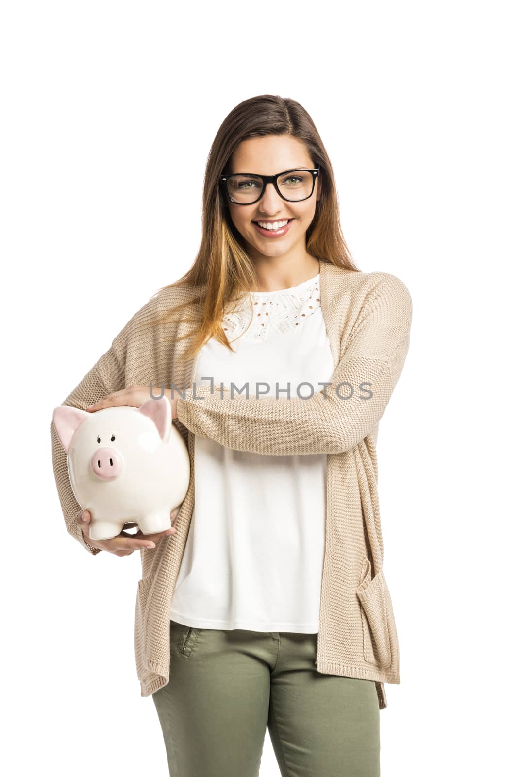 Beautiful and happy woman holding a piggy bank, isolated over white background