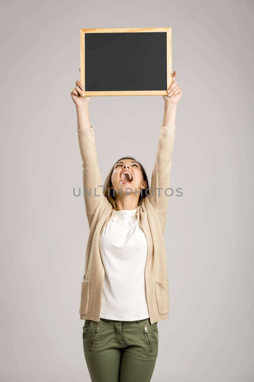 Woman showing something on a chalkboard by Iko