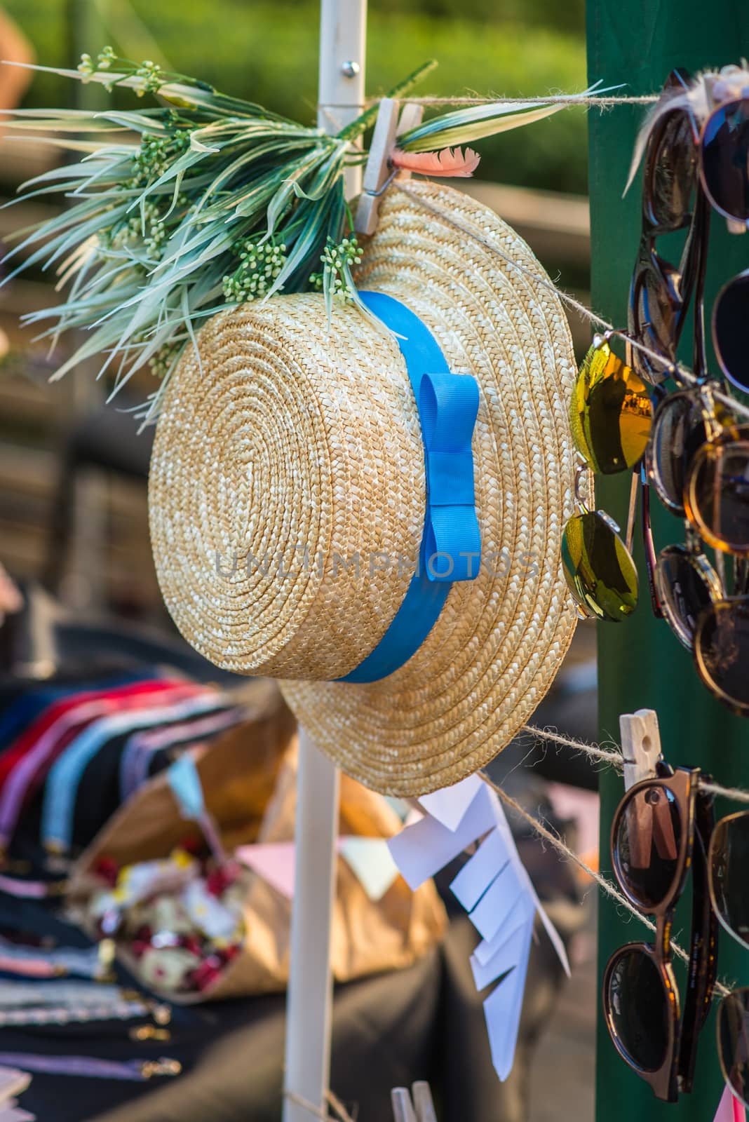 Straw hat with a blue ribbon at the fair