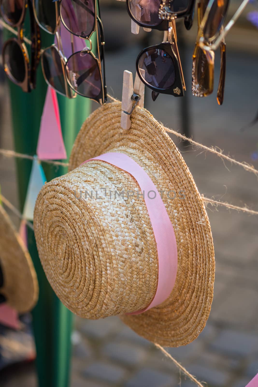 Straw hat with a pink ribbon at the fair