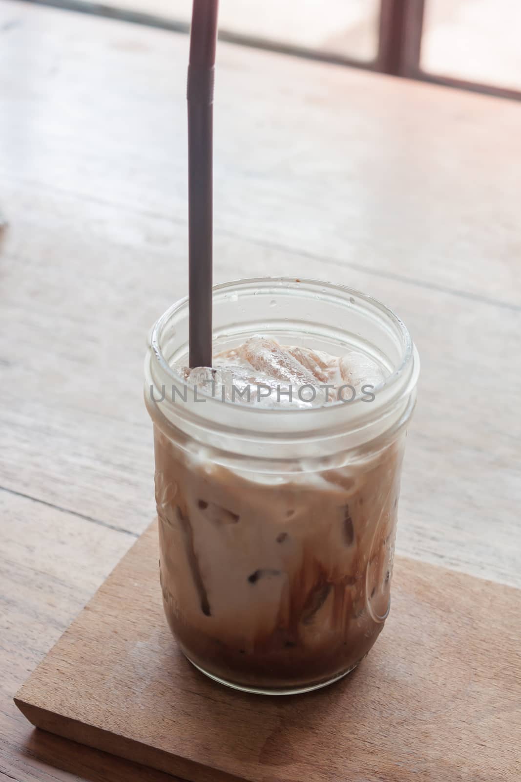 Iced coffee on wooden table, stock photo