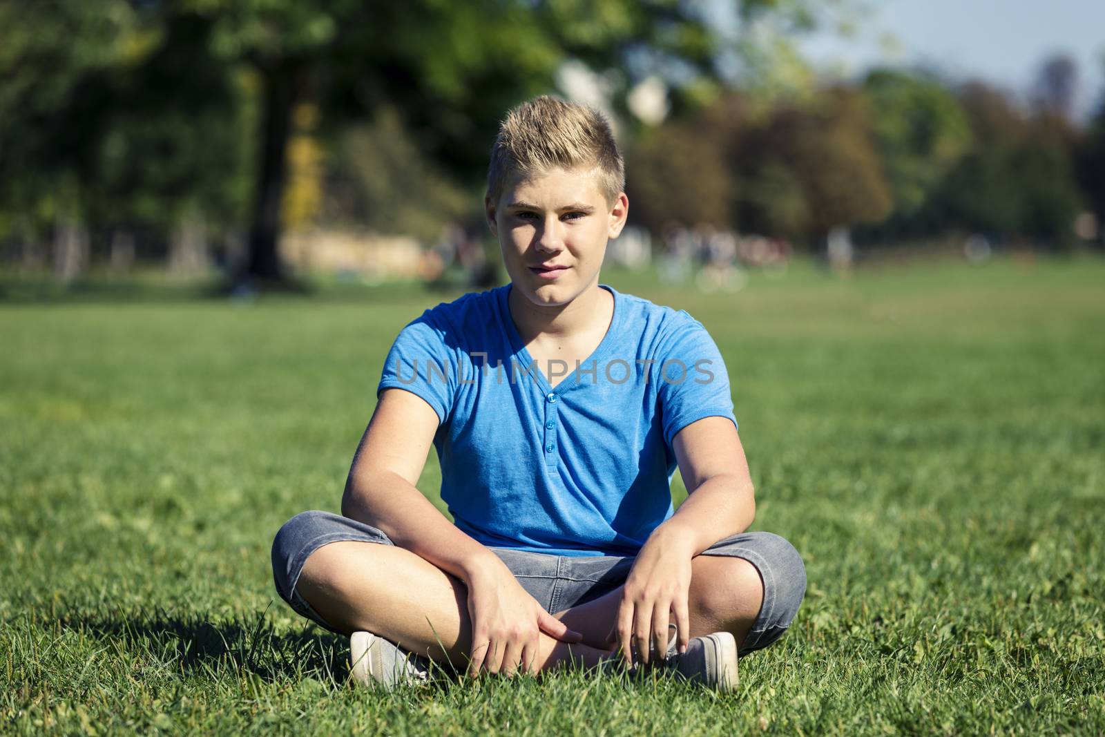 Portrait of a boy fourteen years of age in the grass