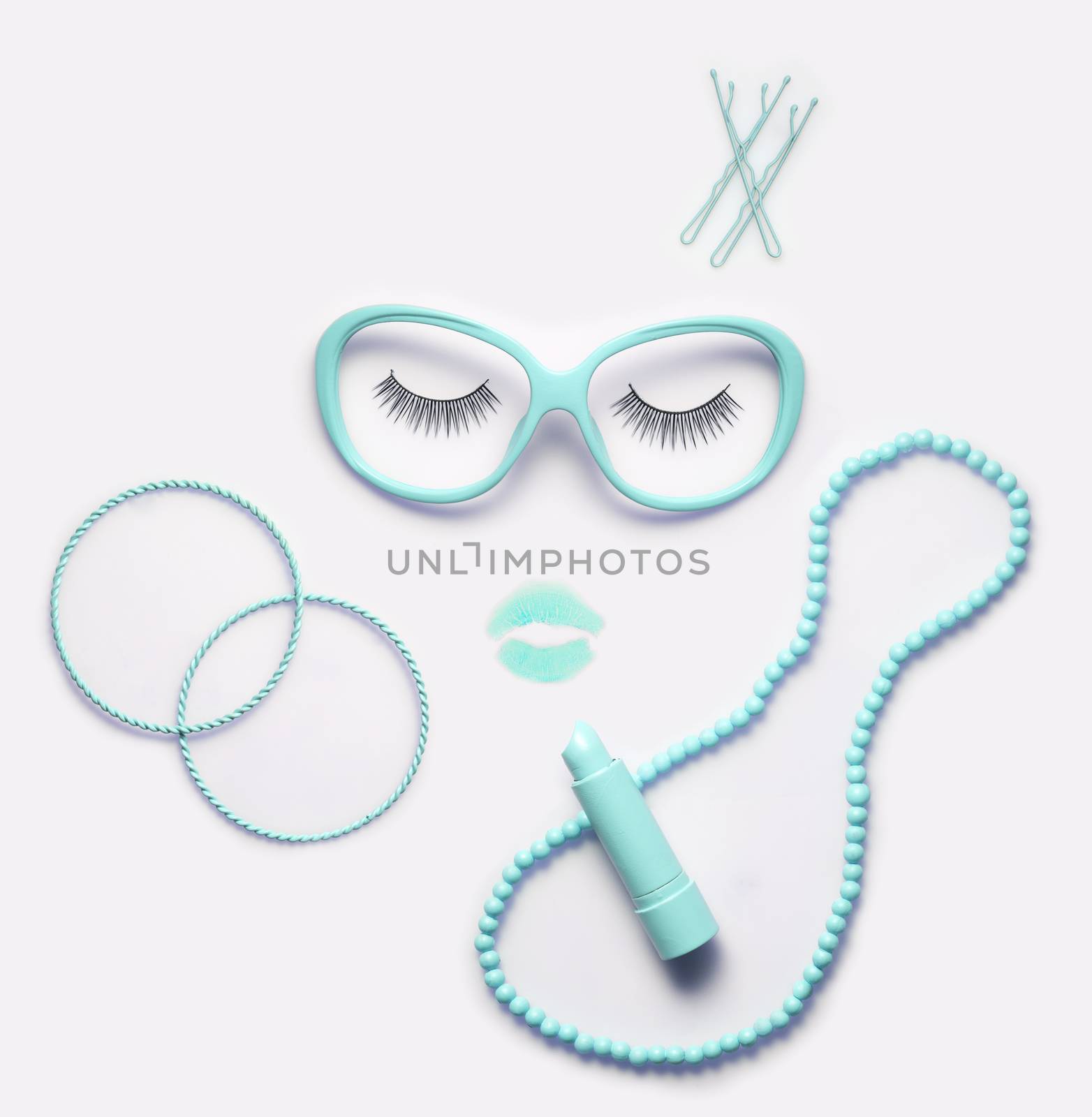 Creative concept photo of accessory and makeup set as a portrait of a woman on white background.
