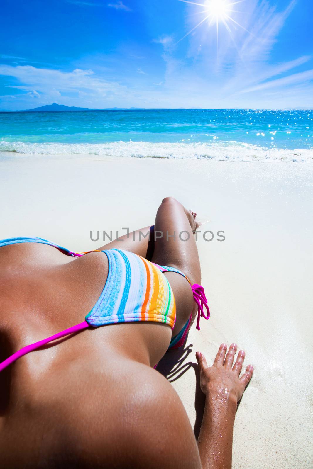 Young beautiful sexy woman relaxing on the beach