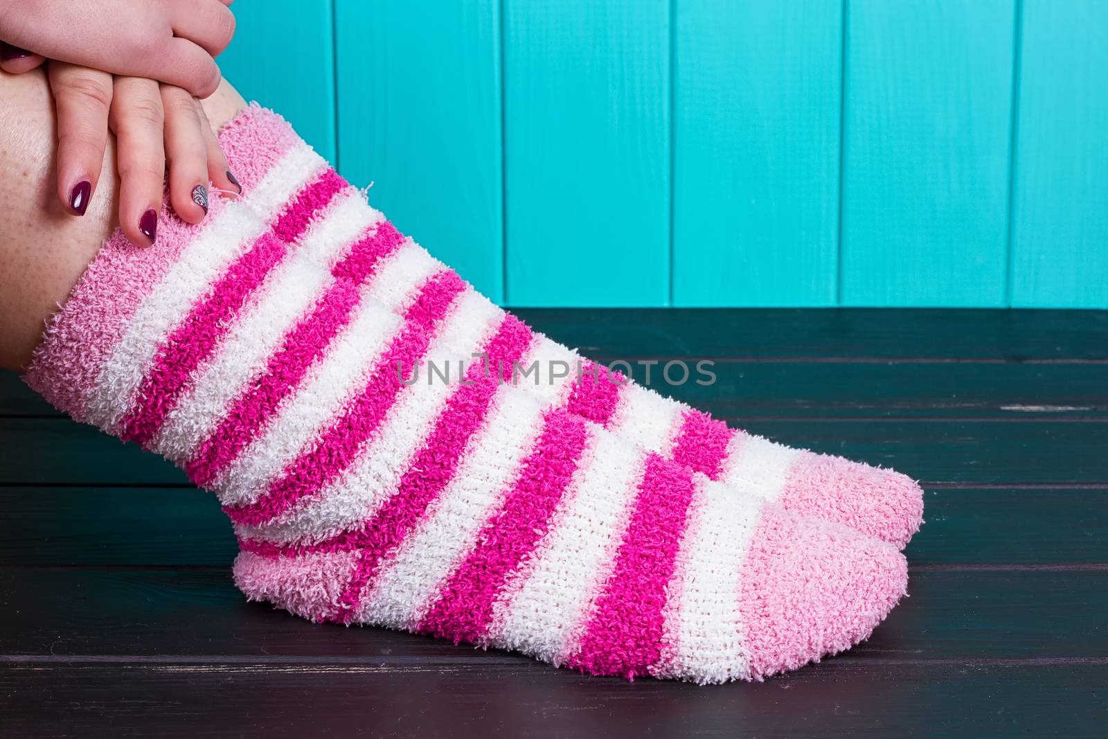 beautiful legs woman with socks standing on tiptoe on the wooden floor
