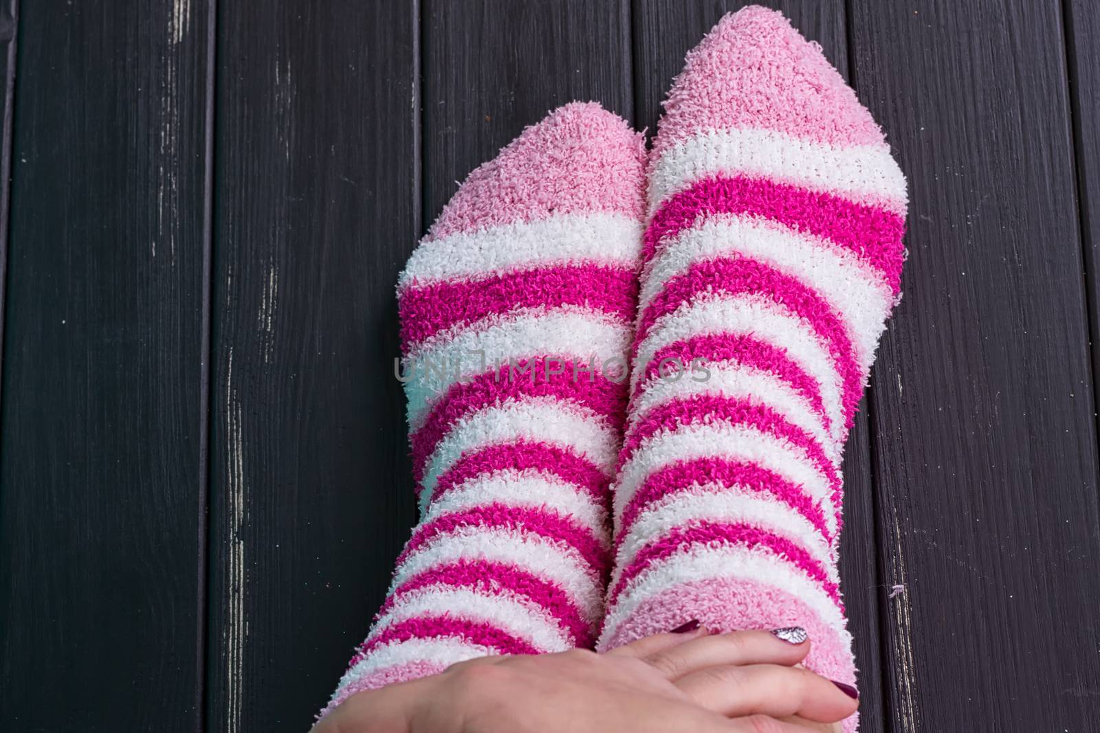beautiful legs woman with socks standing on tiptoe on the wooden floor