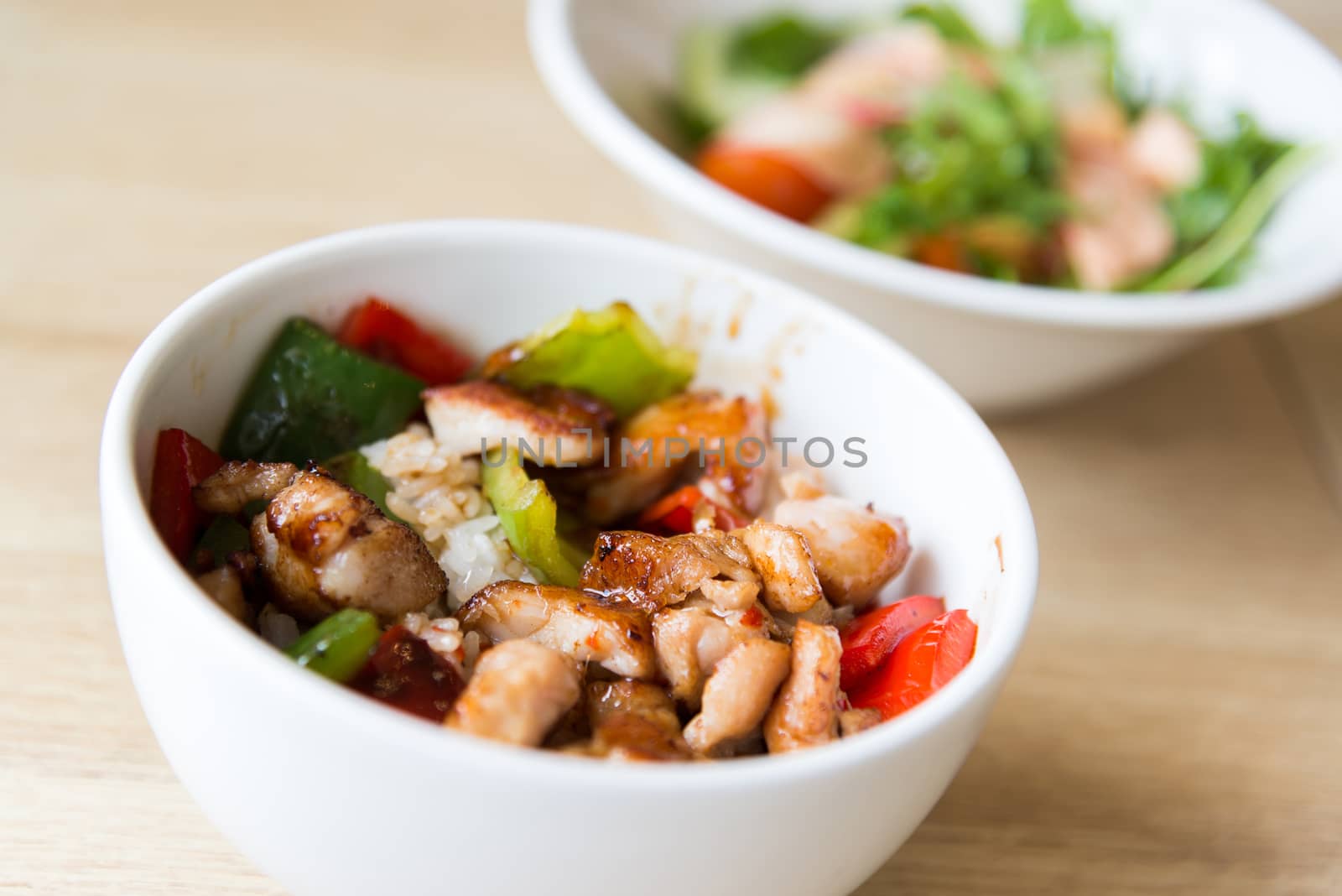 Hot meat salad in white plate by olgavolodina