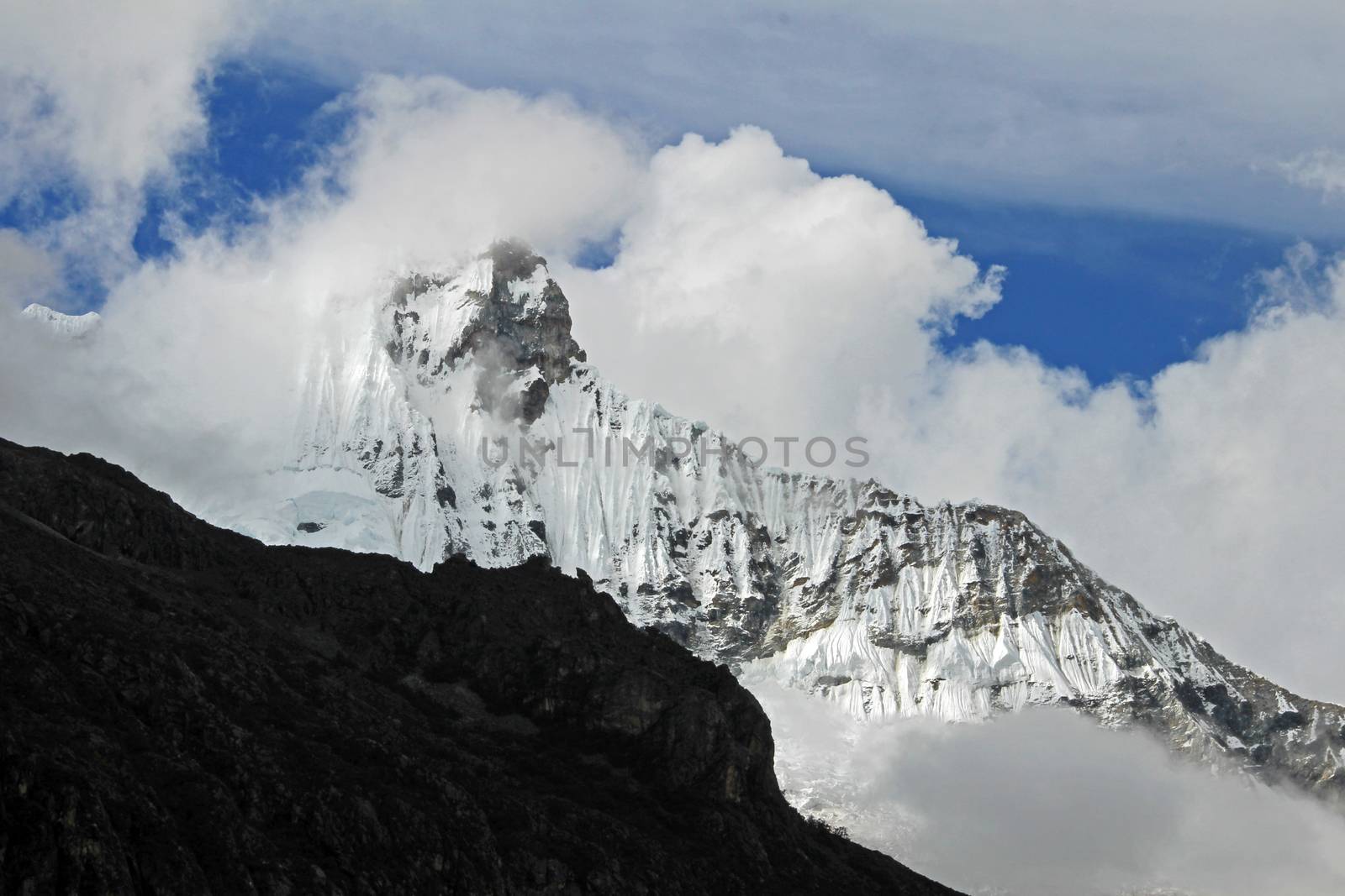 Huandoy mountain peak with clouds in the peruvian Cordillera Blanca