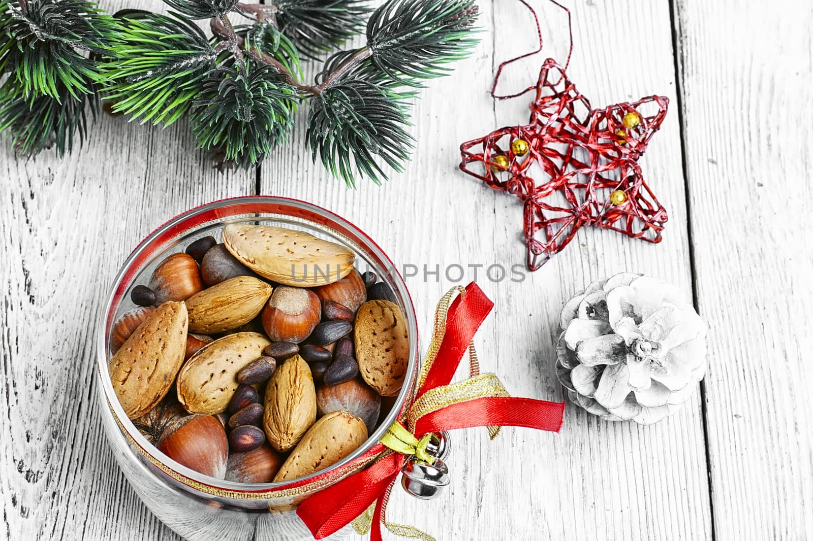 Glass Christmas jar with hazelnuts,almonds and nuts