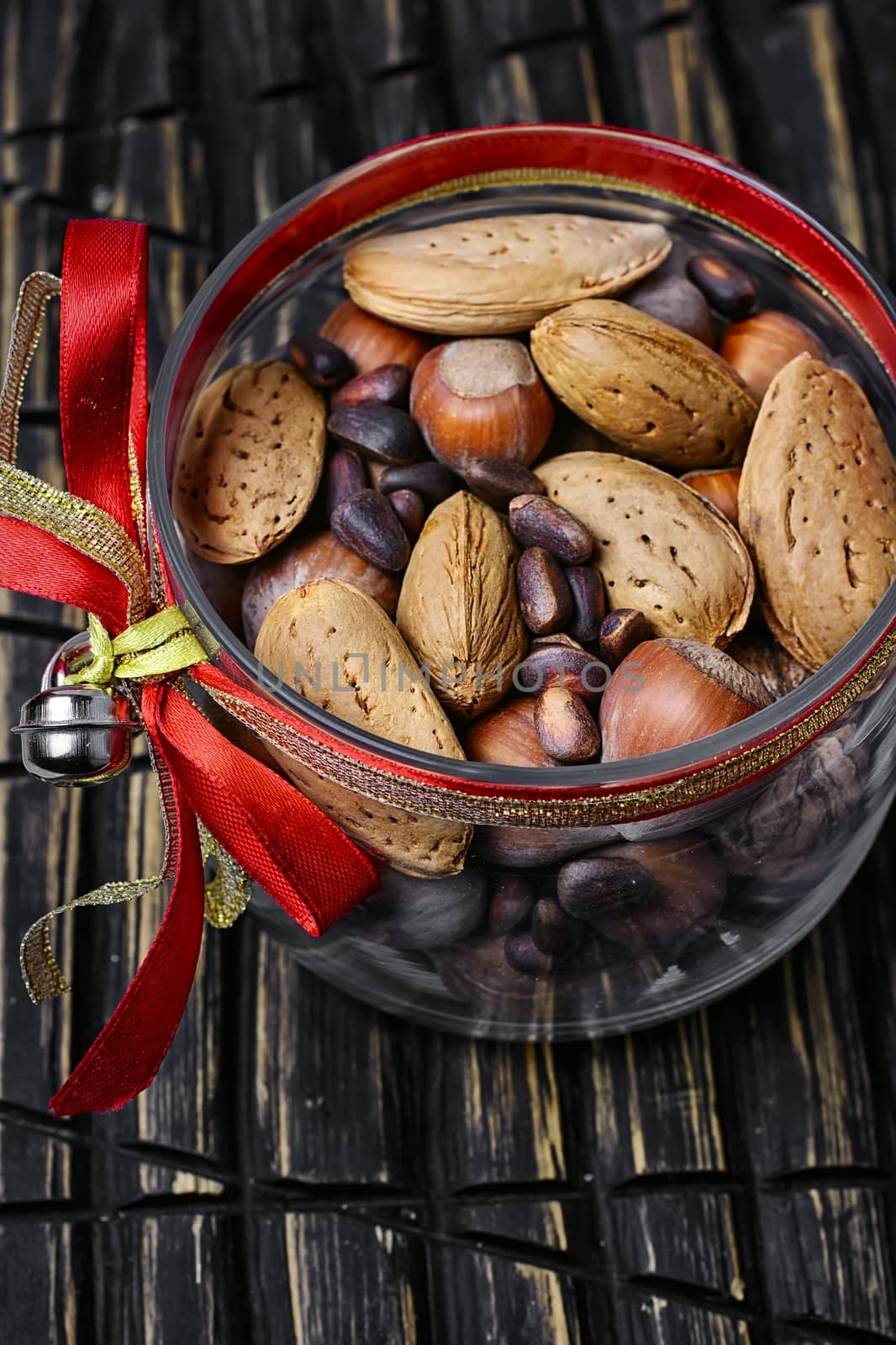 Glass Christmas jar with hazelnuts,almonds and nuts