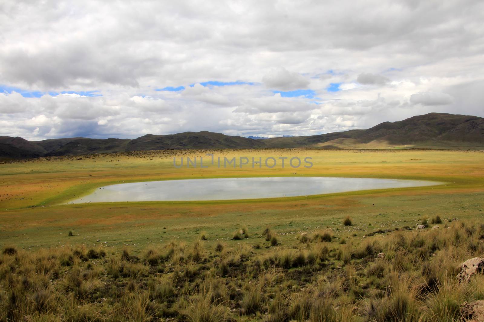 The colorful mountains and a nice lake in the peruvian andes on the way to Colca canyon