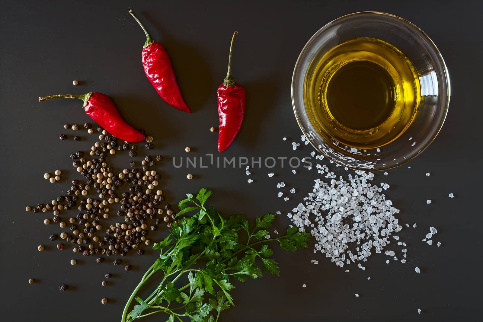 Fresh chili, parsley, oil, salt and pepper seen from above