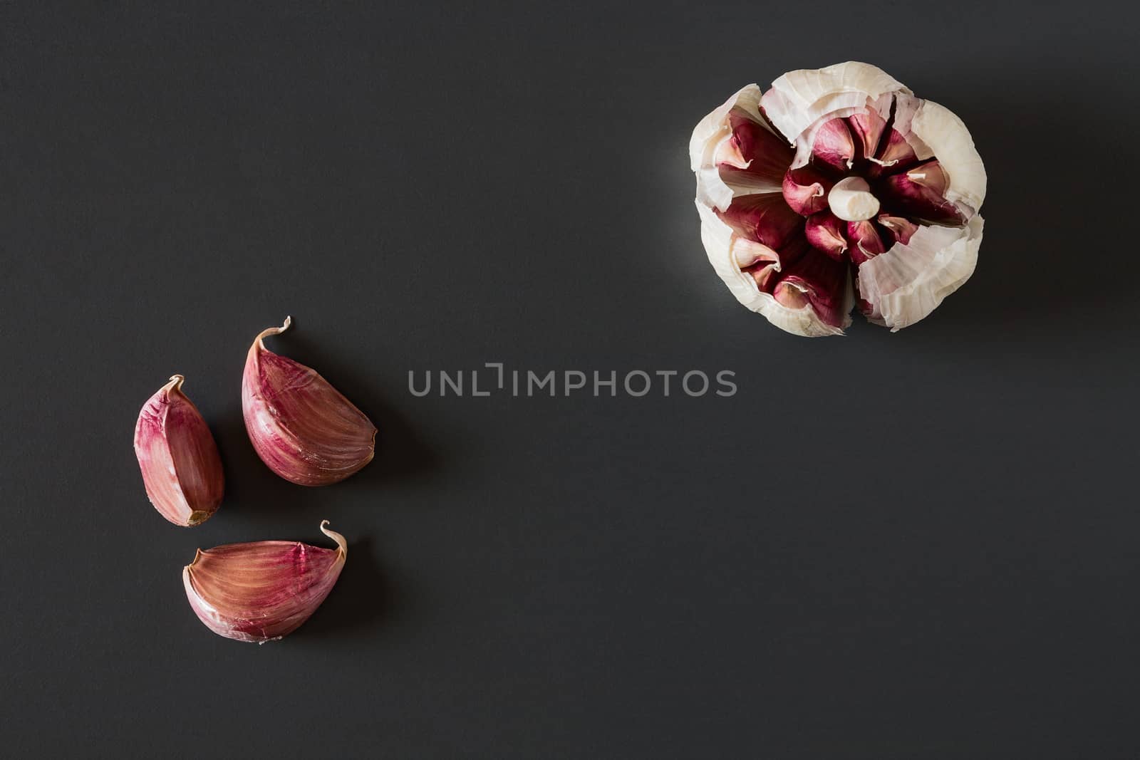Garlic cloves over a dark background by LuigiMorbidelli