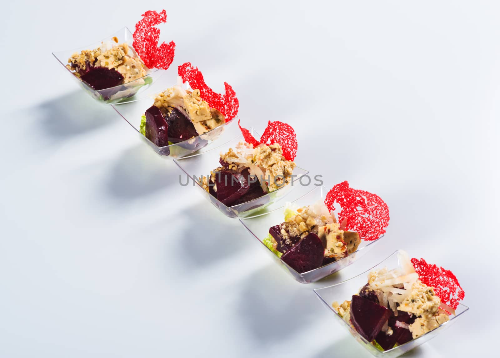 Salad with beet and cauliflower in glass on light background