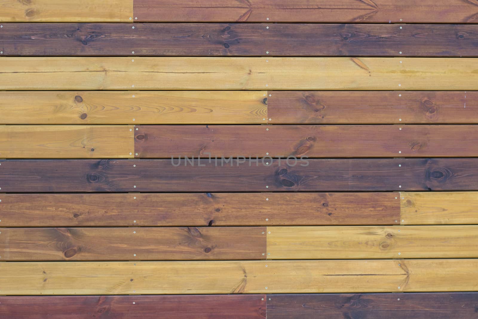 Wooden background of gorizontal yellow and brown pallets