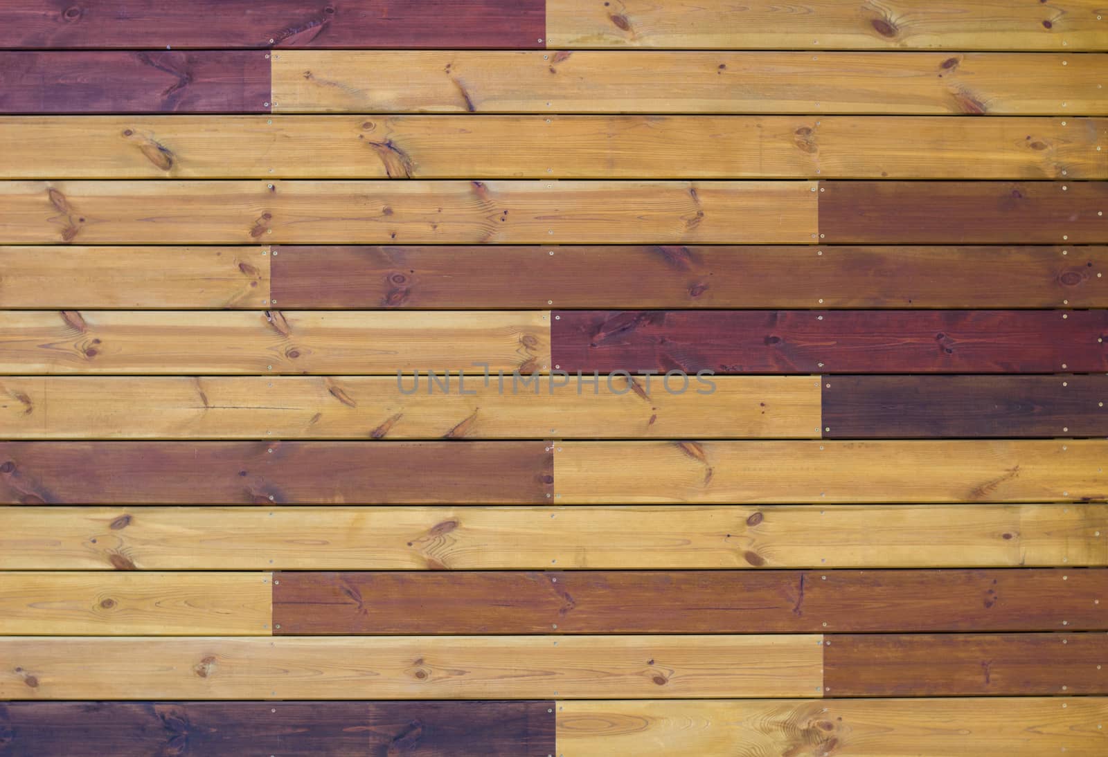 Wooden background of gorizontal brown and yellow pallets