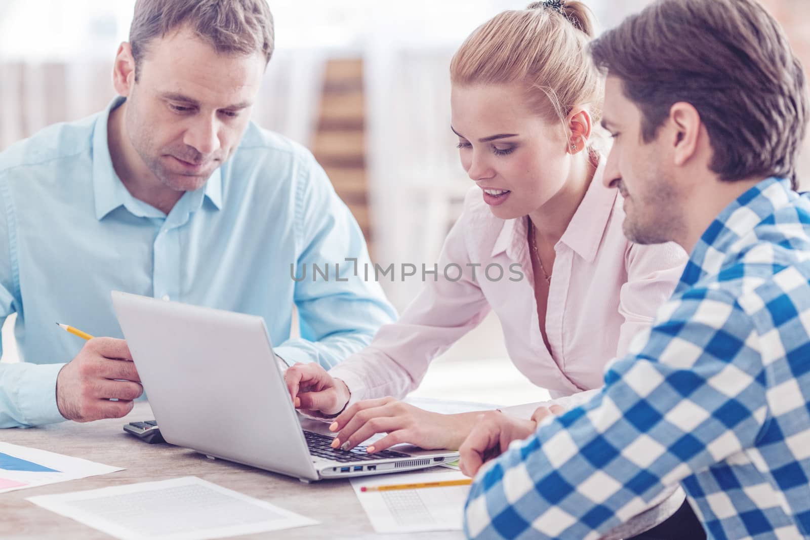 Diverse people working with financial reports and laptop