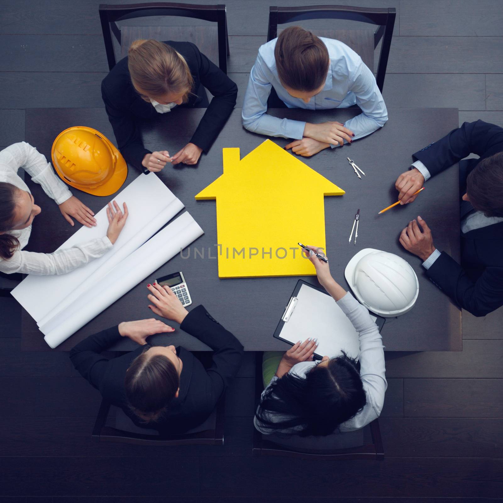 Top view of people around table in construction business meeting