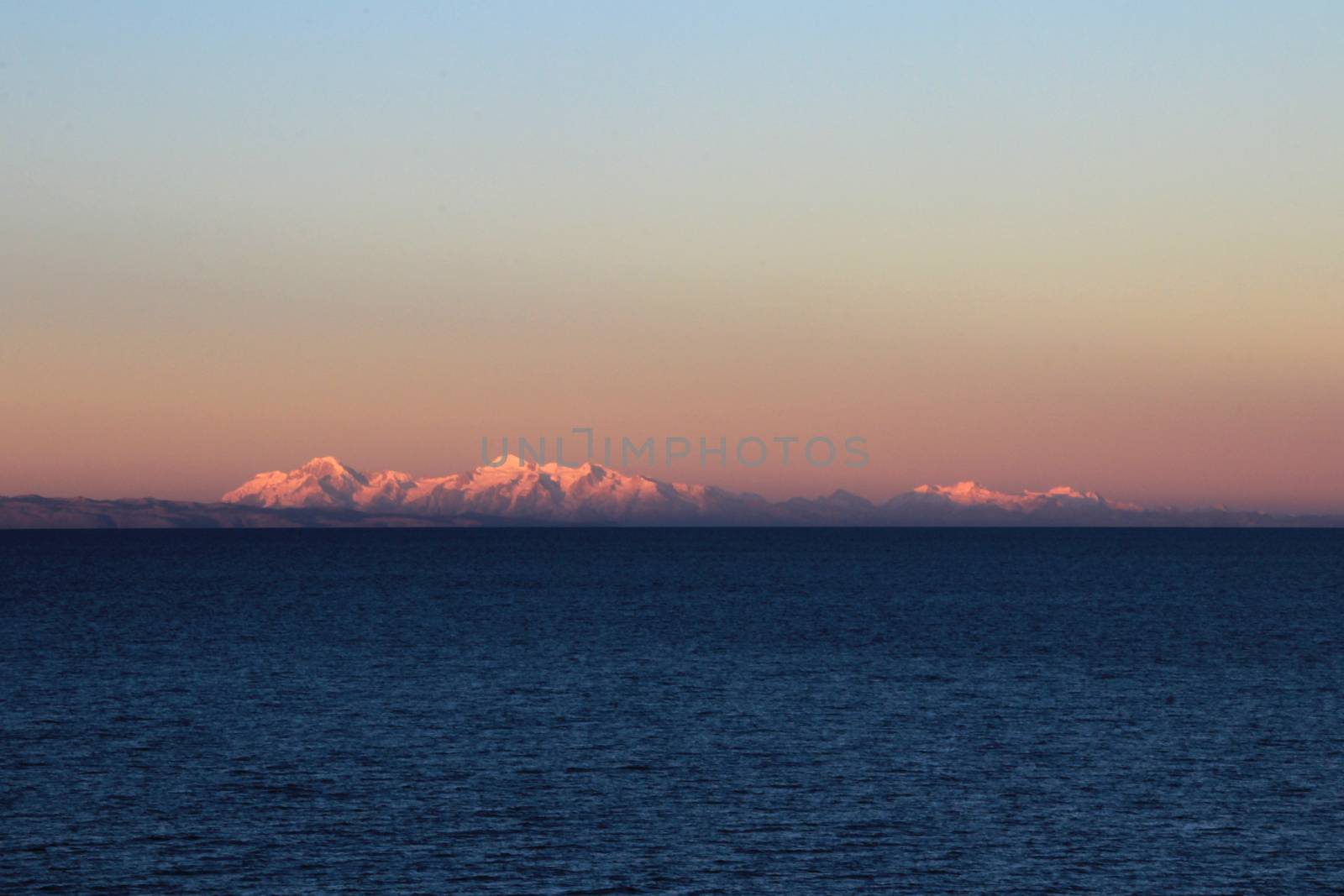 Cordillera real mountain range at sunset behind Titicaca lake, view from the peruvian side.