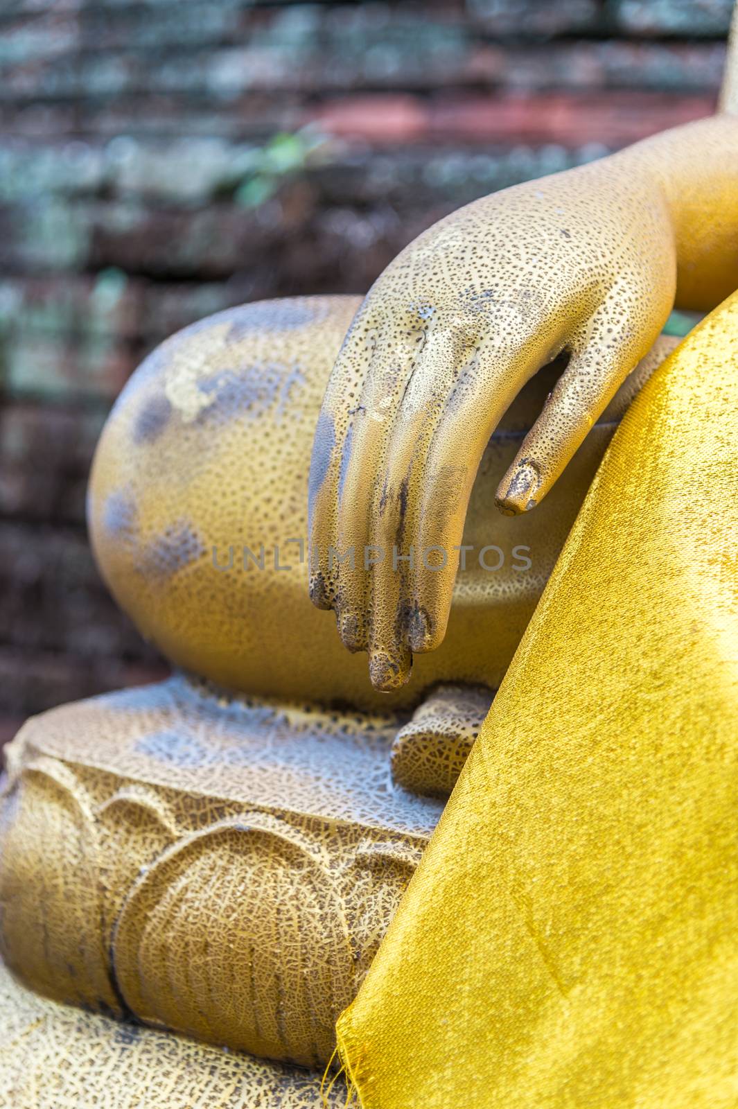 Hand of Buddha with old brick wall background