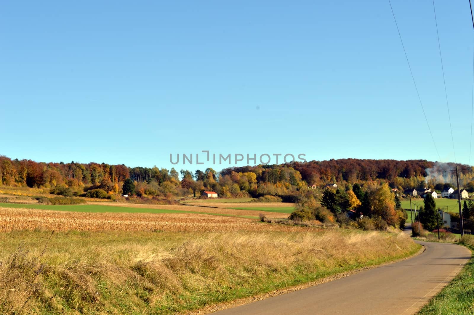 Plow fields with a background hill and a village