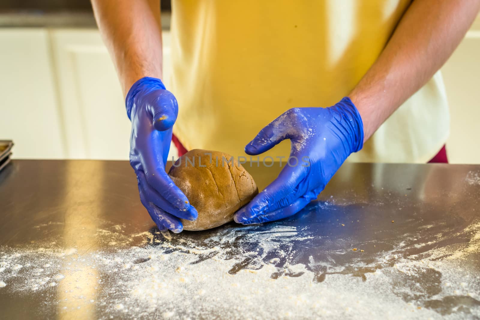 Hands knead dough with gloves by okskukuruza