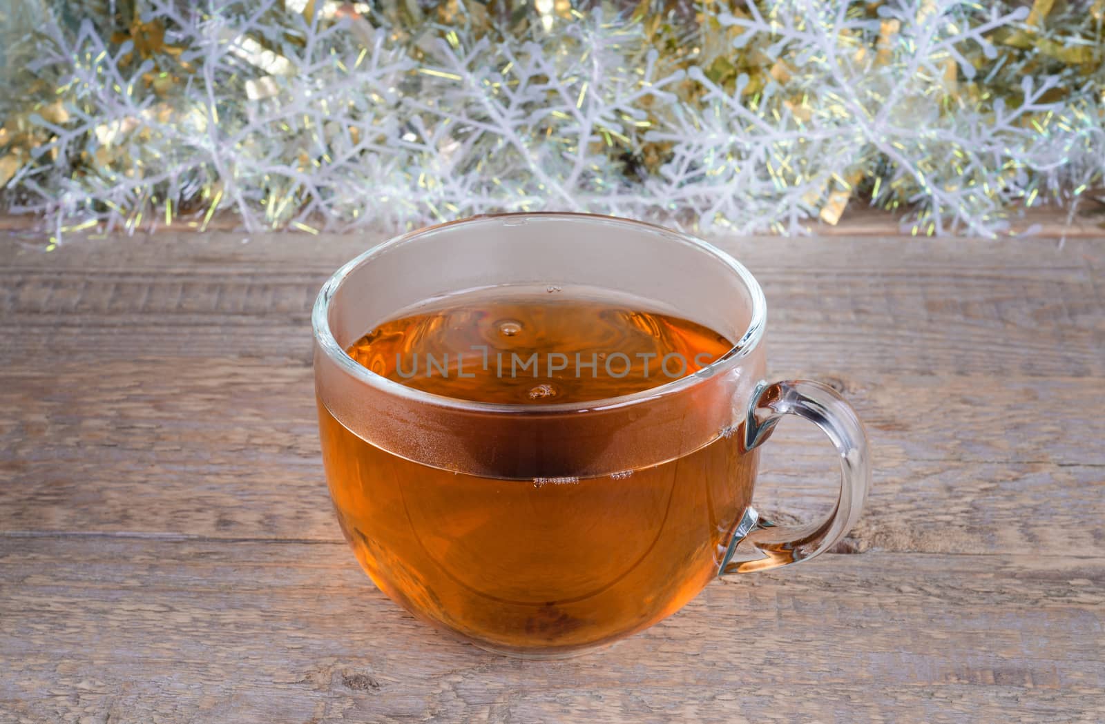 Cup of hot tea on background and old wooden surface. Place for text.