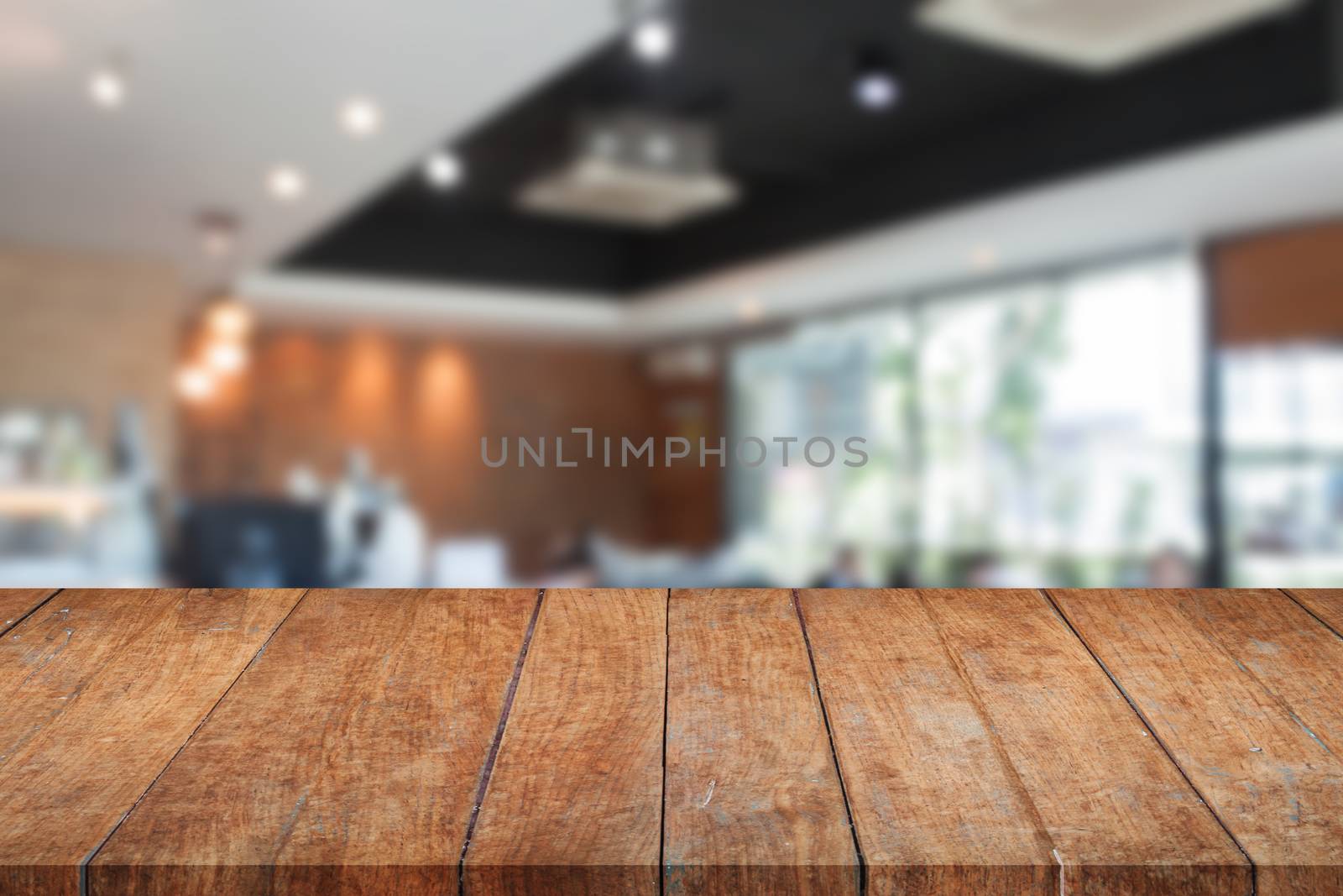 Top of perspective brown wooden with blurred cafe interior for background. product display template