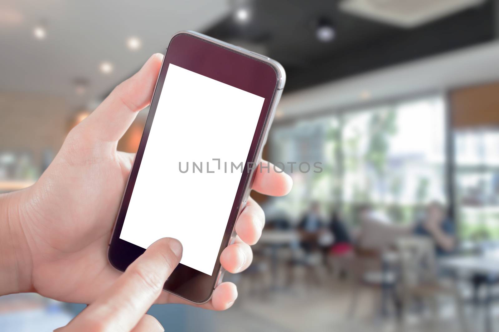 Women hand holding smartphone with blurred cafe interior for background