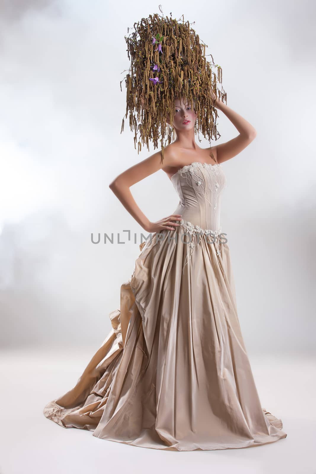 Young beautiful woman in a wedding dress and a flower composition on her head