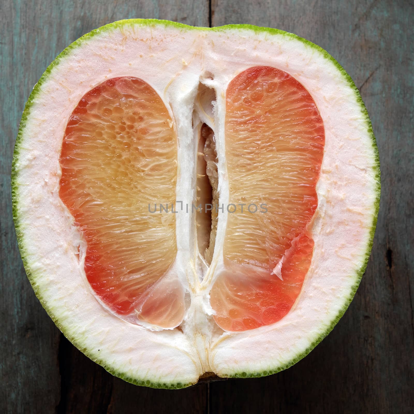 Grapefruit on wood background, tropical fruit by xuanhuongho