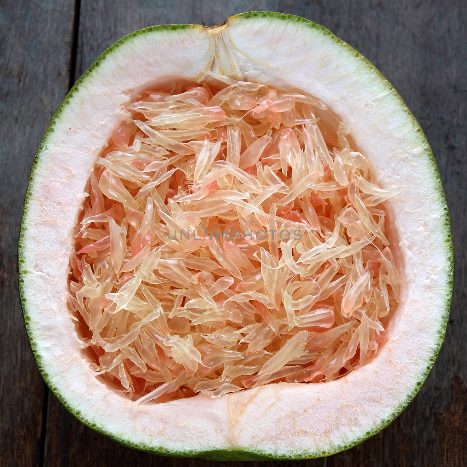 Grapefruit on wood background, tropical fruit by xuanhuongho