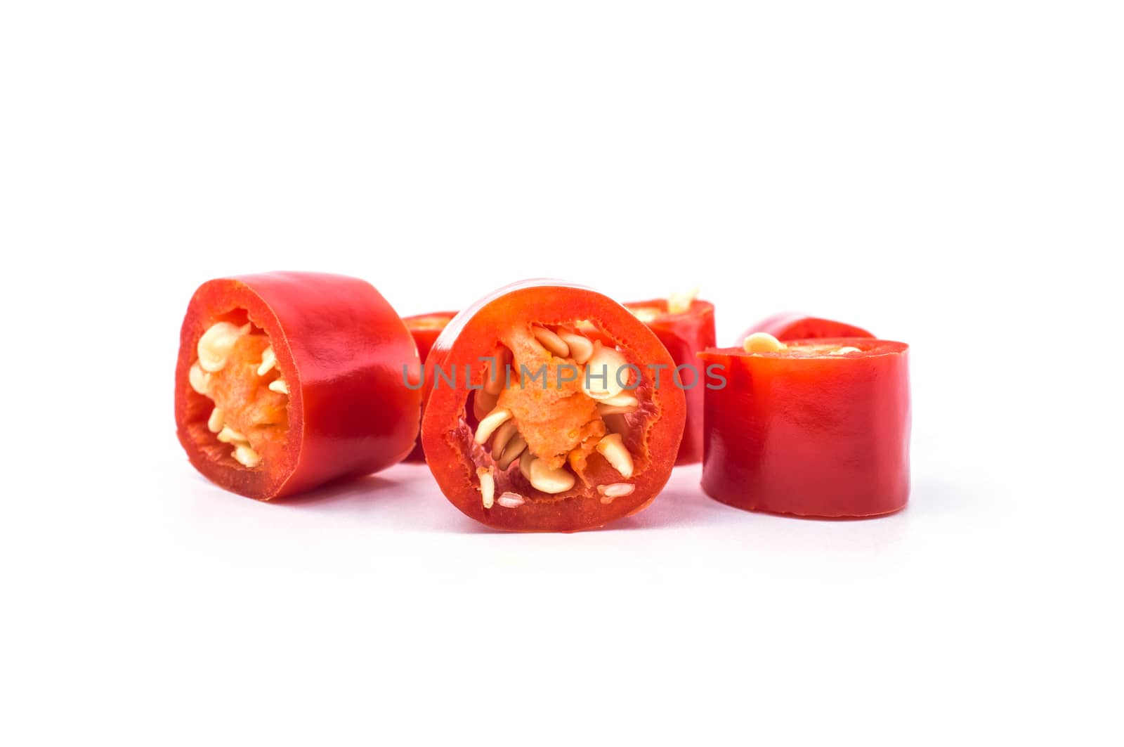 Red chilli pepper slices on white background. by koson