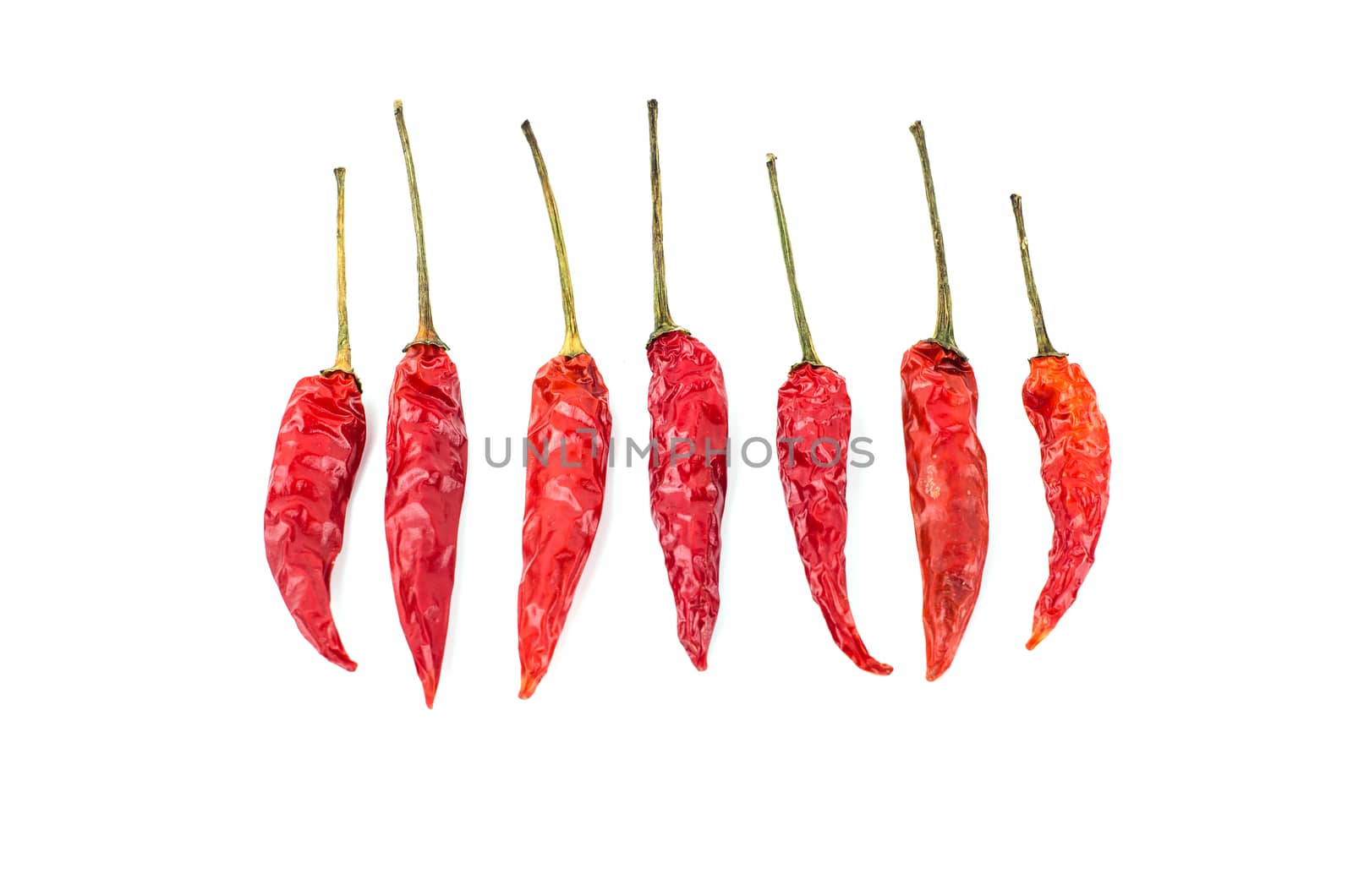 Dried red chili peppers isolated on white background. Food ingredient for spicy cooking.