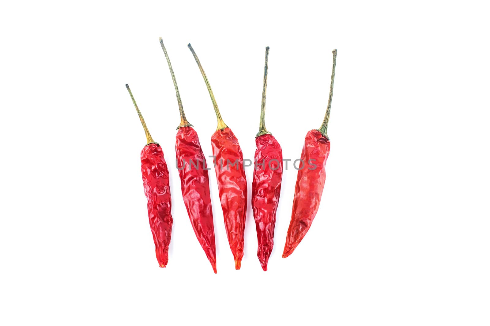 Dried red chili peppers isolated on white background. Food ingredient for spicy cooking.