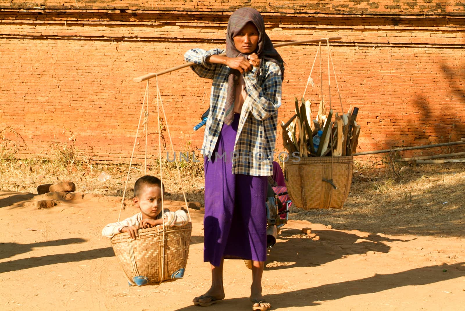 Woman with her son on a basket at the archaeological site of Bag by Fotoember