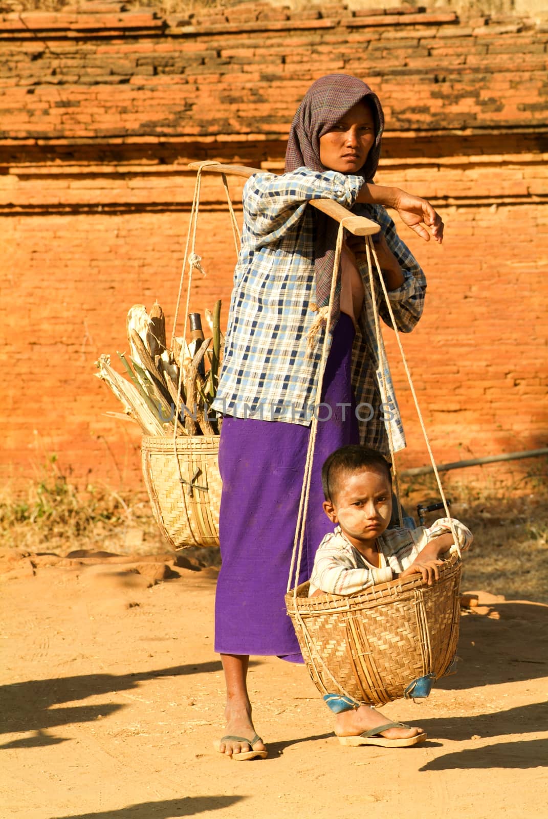 Woman with her son on a basket at the archaeological site of Bag by Fotoember