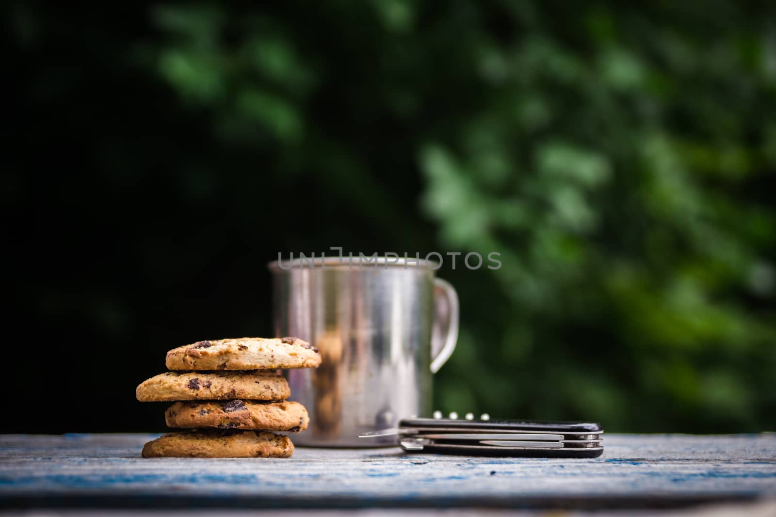 Cookies, tourist metal cup on a table outdoors by photoboyko