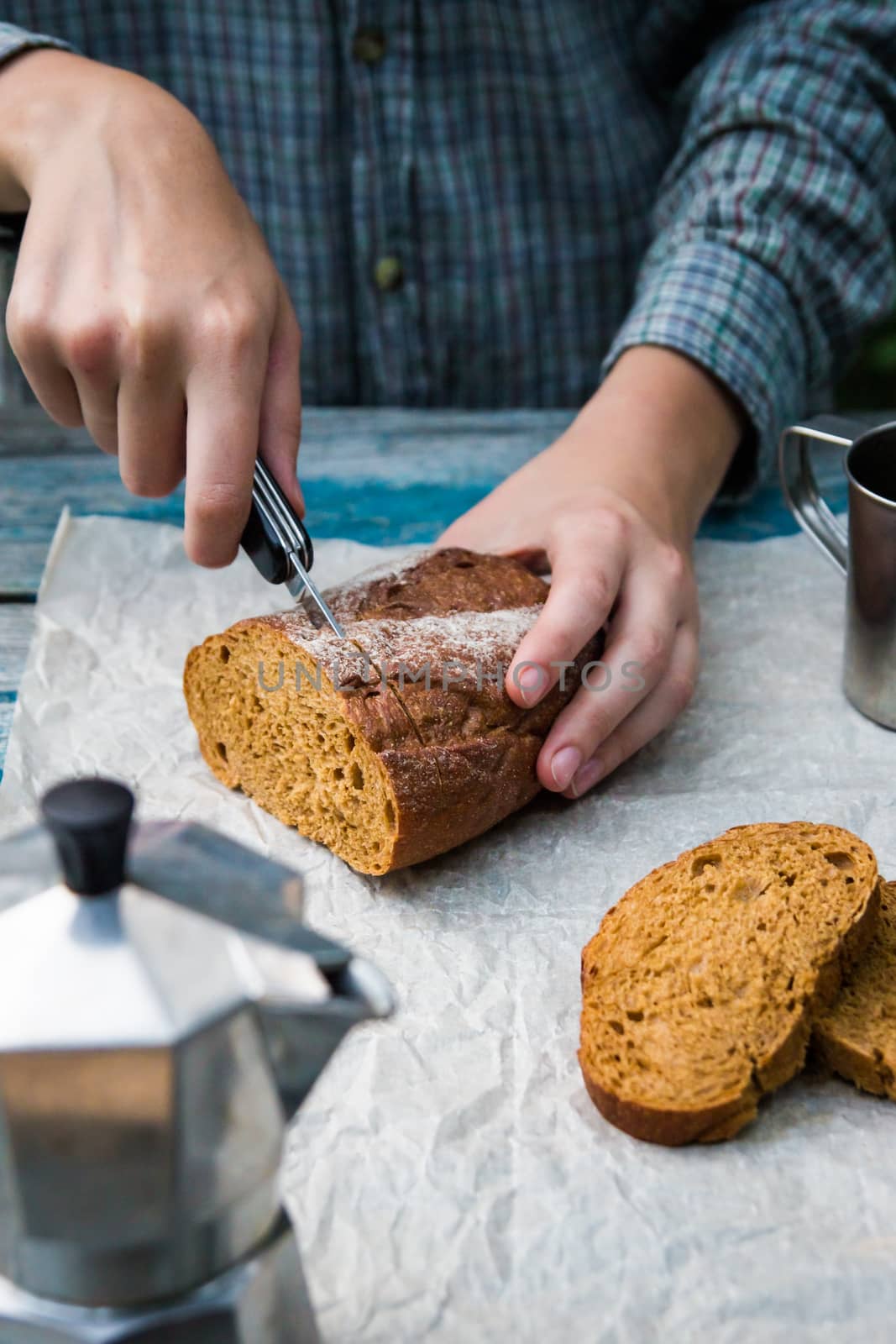 Bread cut on rustic table by photoboyko