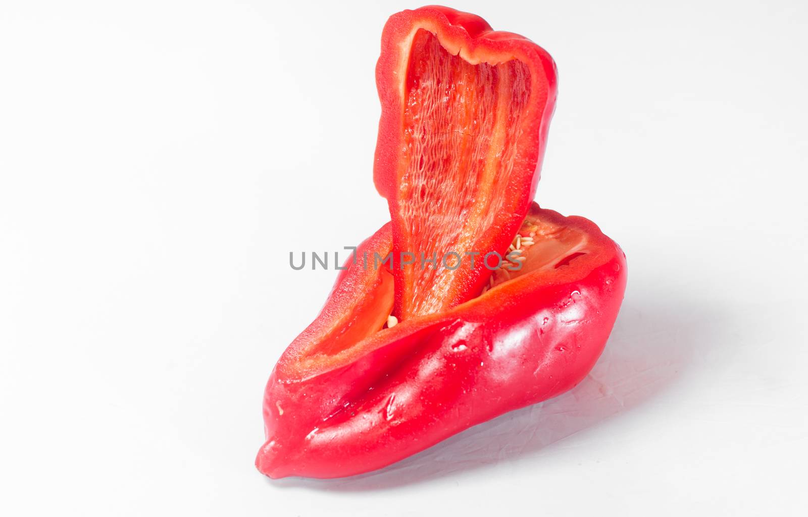 Pieces of red pepper on white background