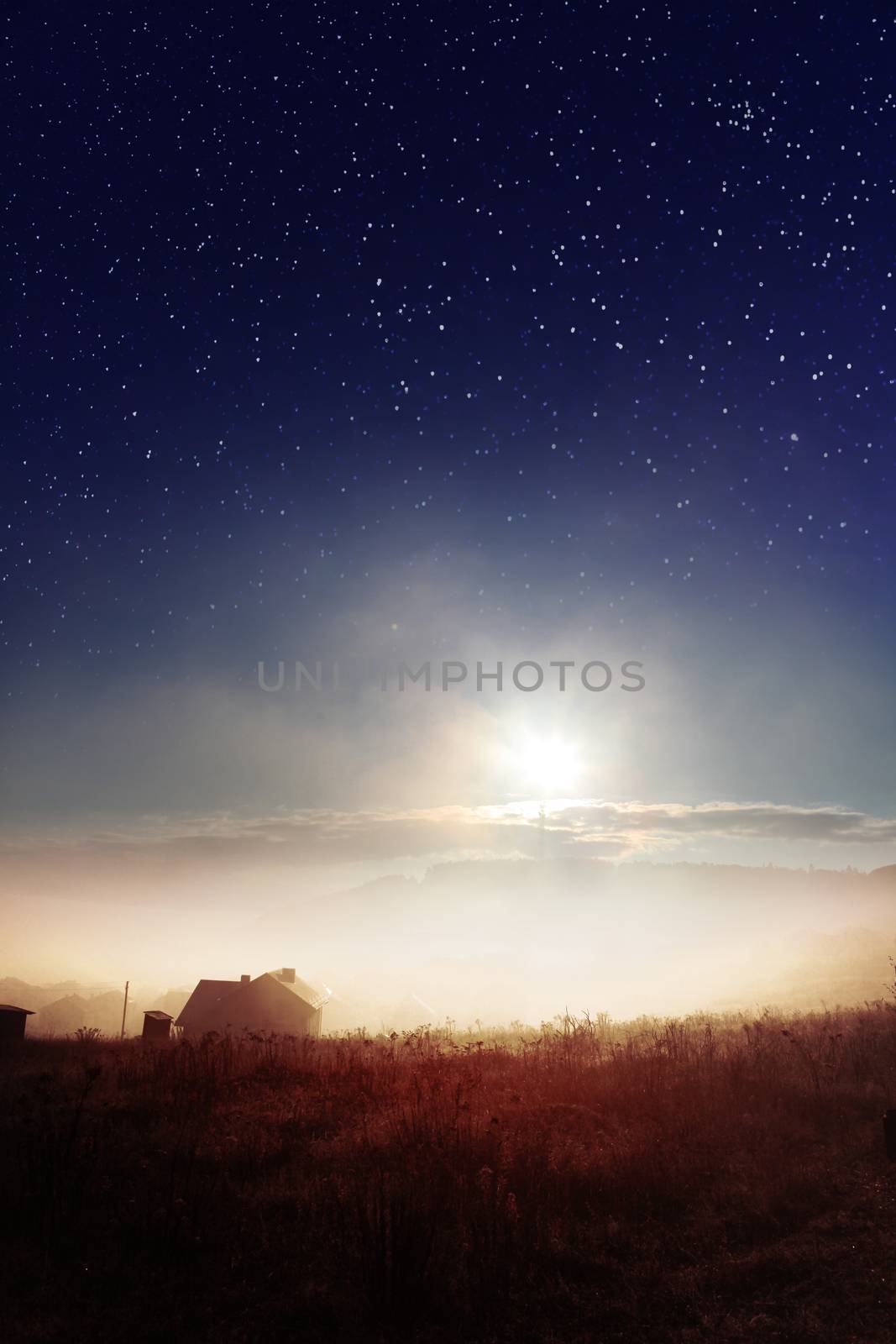 star sky with fog over countryside at autumn