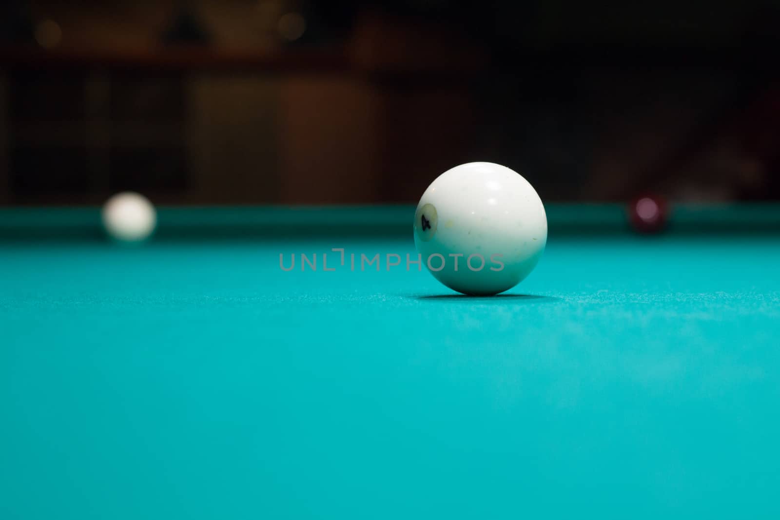 Russian billiards in process, balls on green table